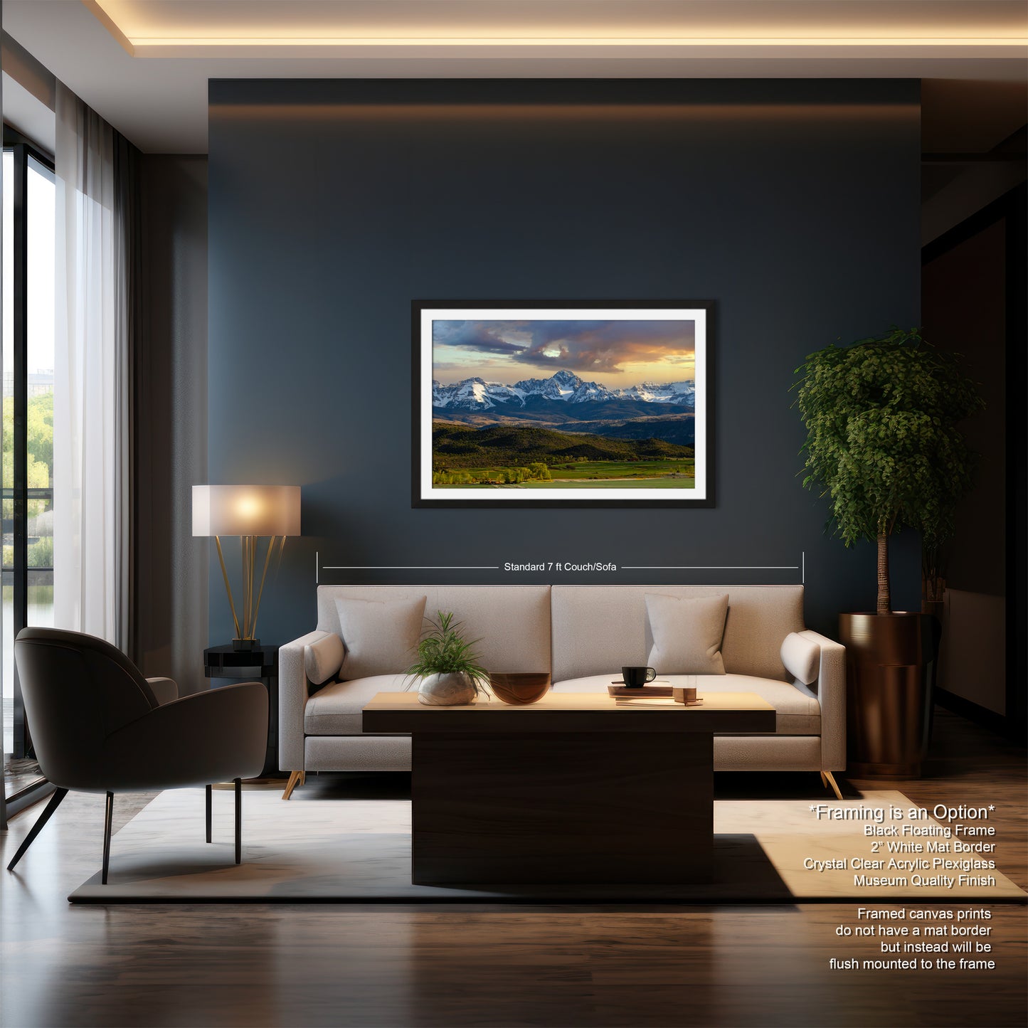 a modern living room with a large framed landscape painting hanging on the wall, a white sofa, a wooden coffee table, and a large window overlooking a scenic outdoor view.