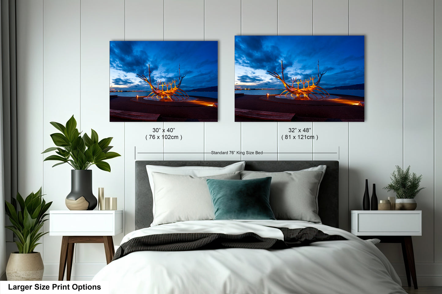 a bed with two pictures hanging on the wall above it