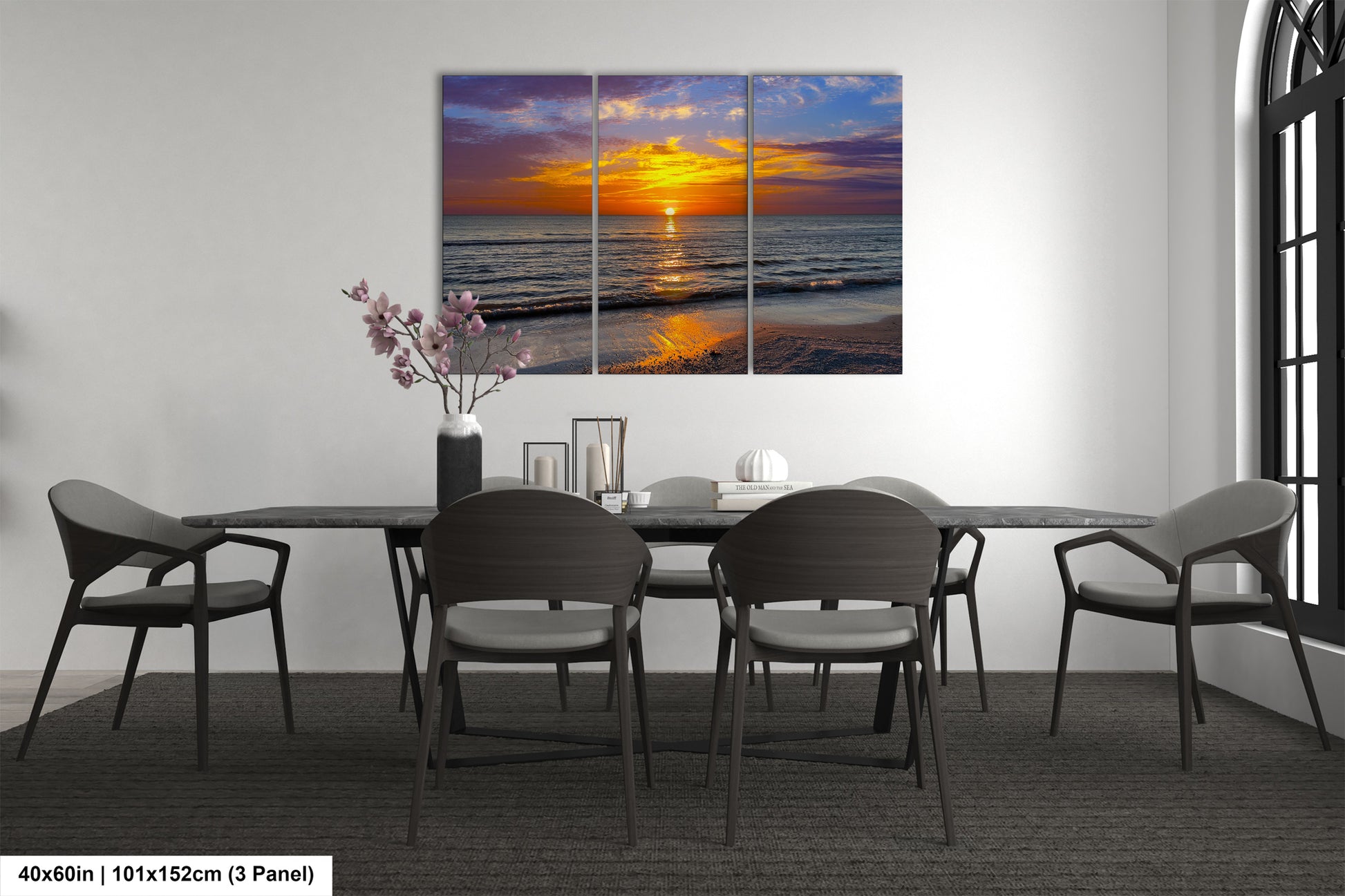 a dining room table with chairs and a painting on the wall