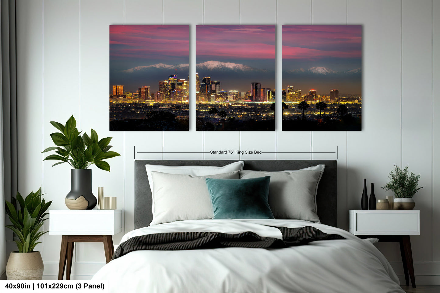 a bedroom with a large bed and two paintings on the wall