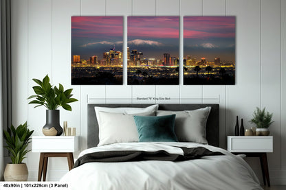 a bedroom with a large bed and two paintings on the wall
