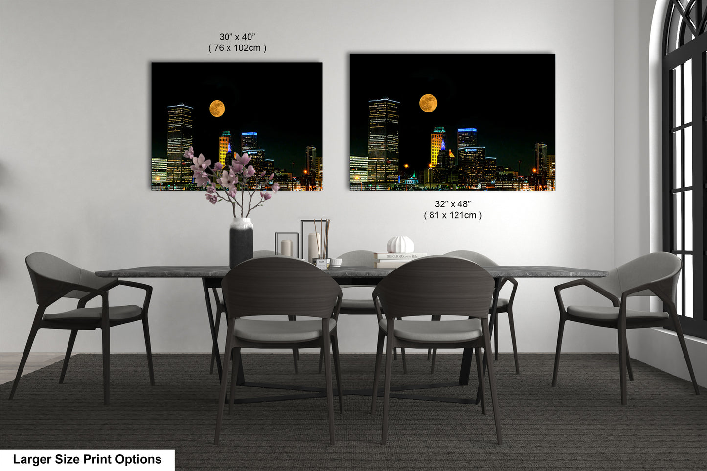 a dining room table with four chairs and a vase with flowers