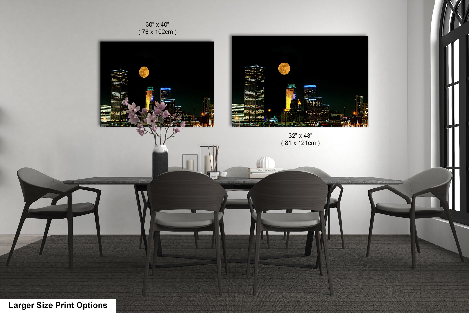 a dining room table with four chairs and a vase with flowers