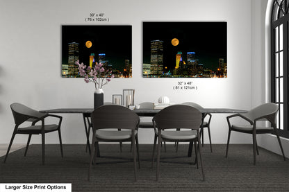 a dining room table with four chairs and a vase with flowers
