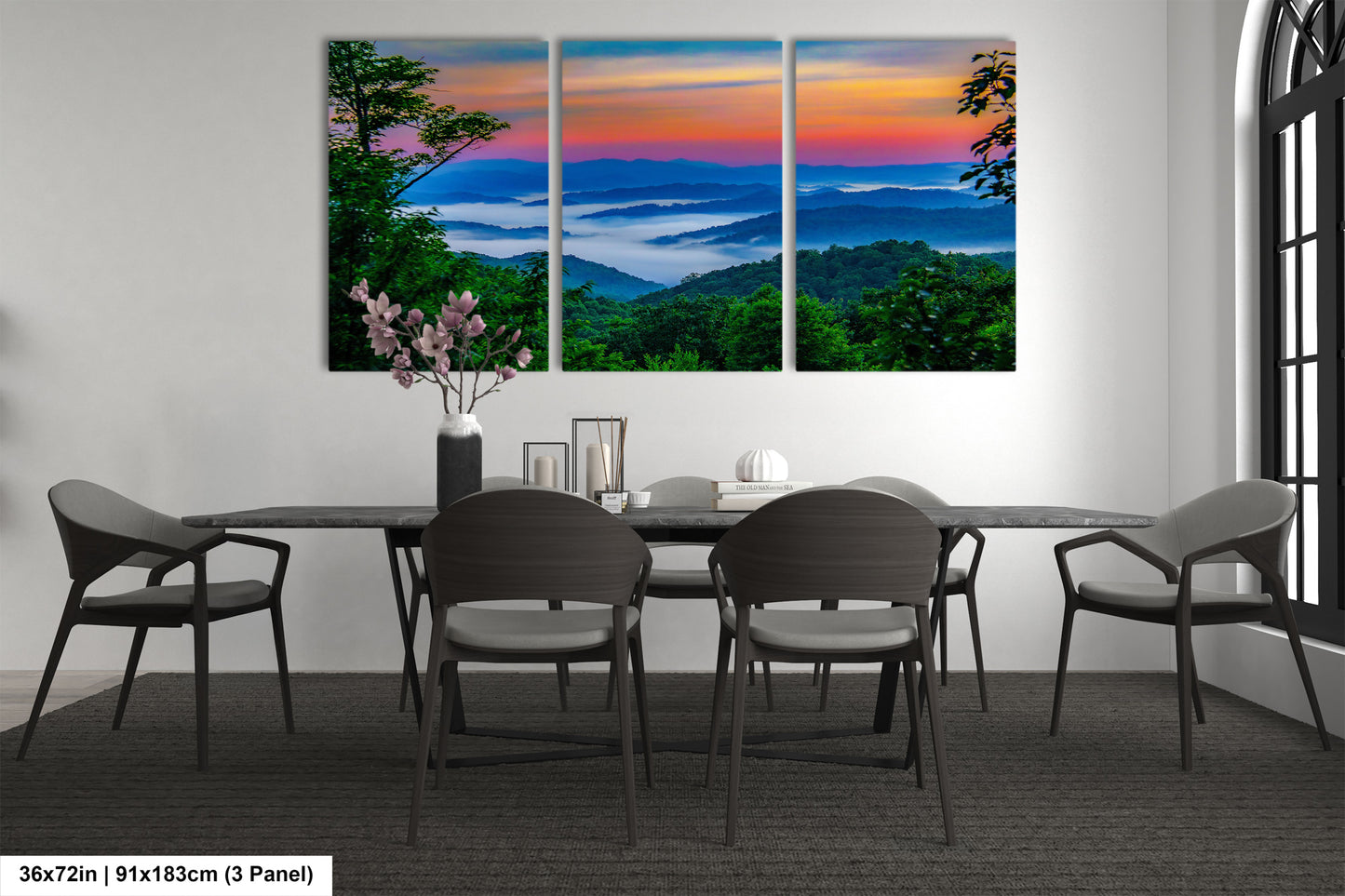 a dining room table with four chairs and a painting on the wall