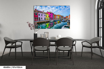 a dining room table with chairs and a painting on the wall