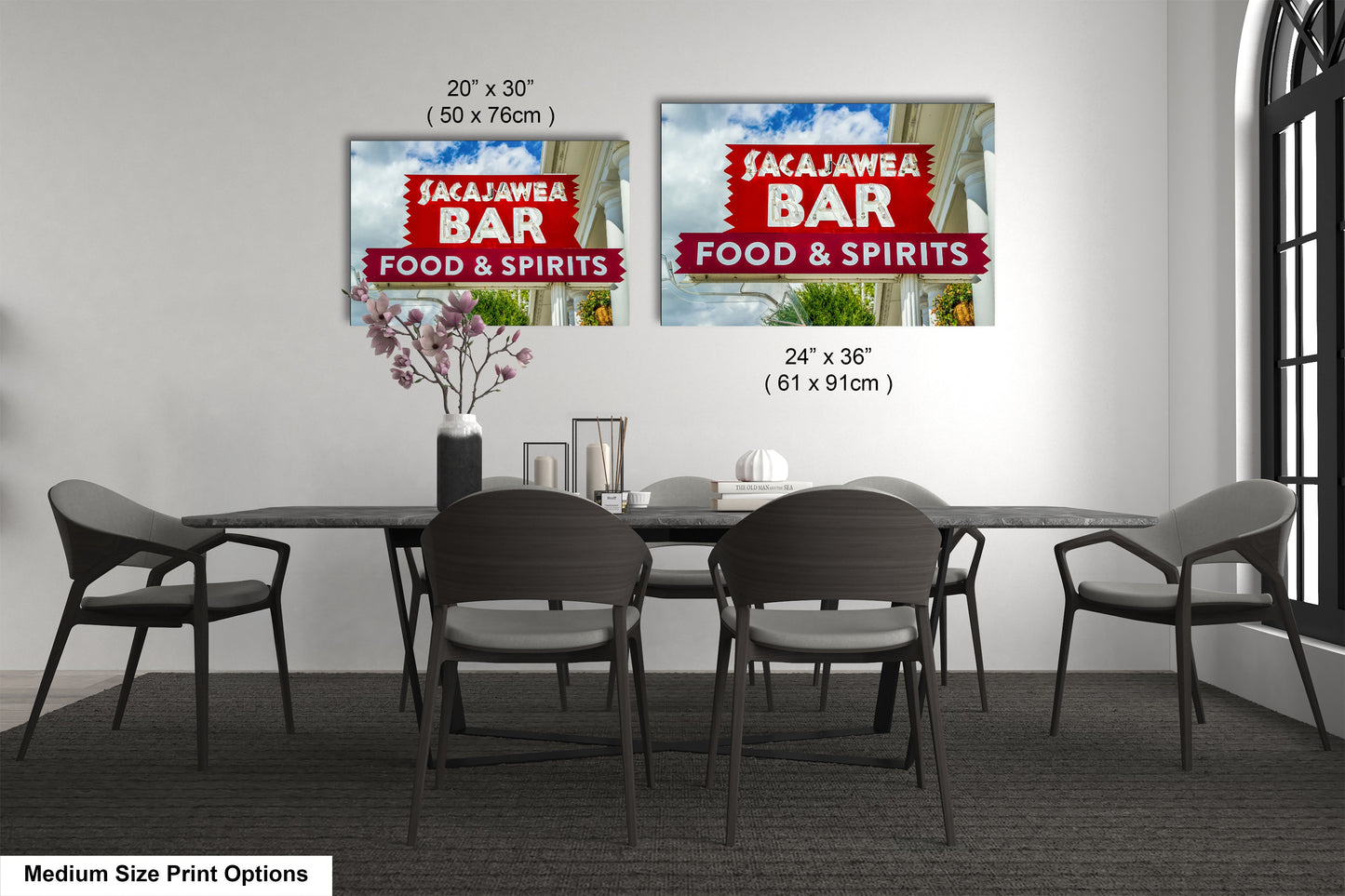 a dining room table with four chairs and a sign on the wall