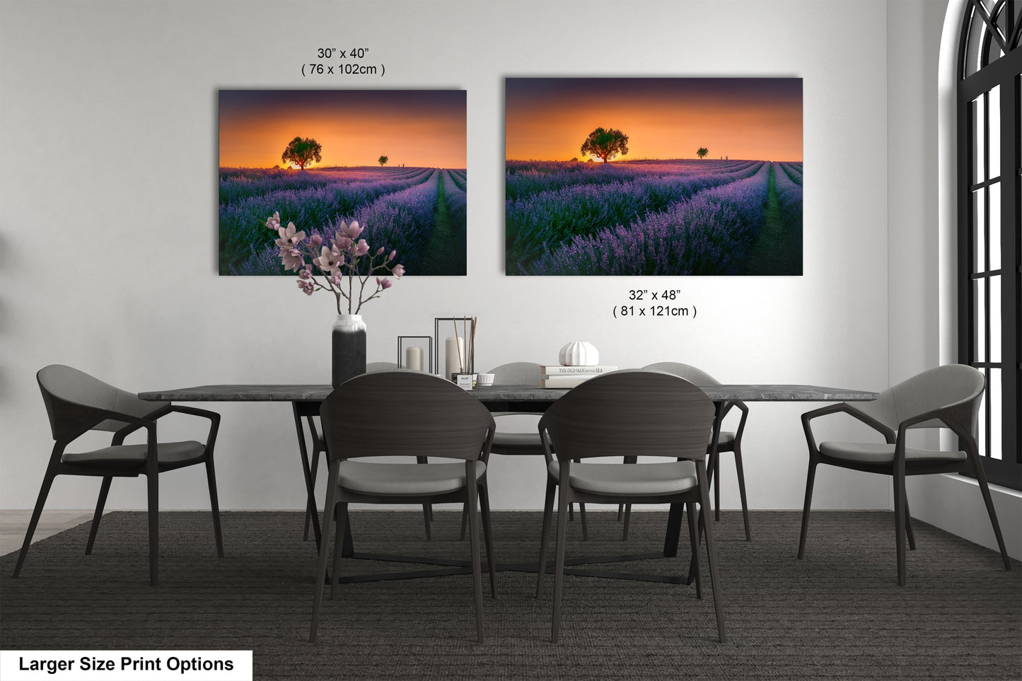 a dining room table with four chairs and a vase of flowers