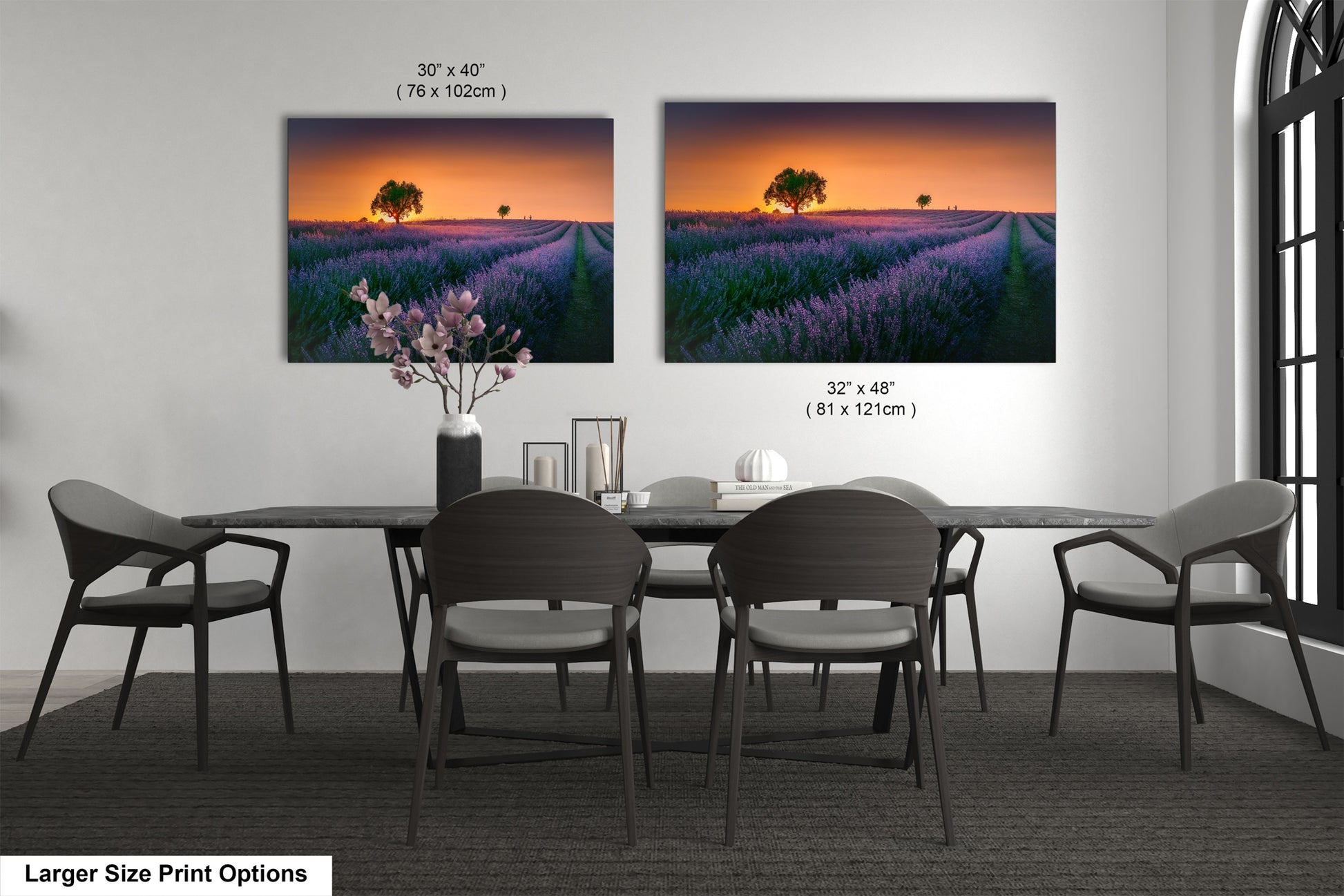 a dining room table with four chairs and a vase of flowers