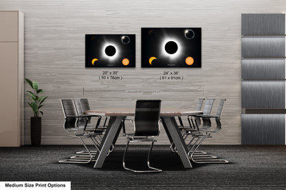 a dining room table with four chairs and two pictures of eclipses on the wall