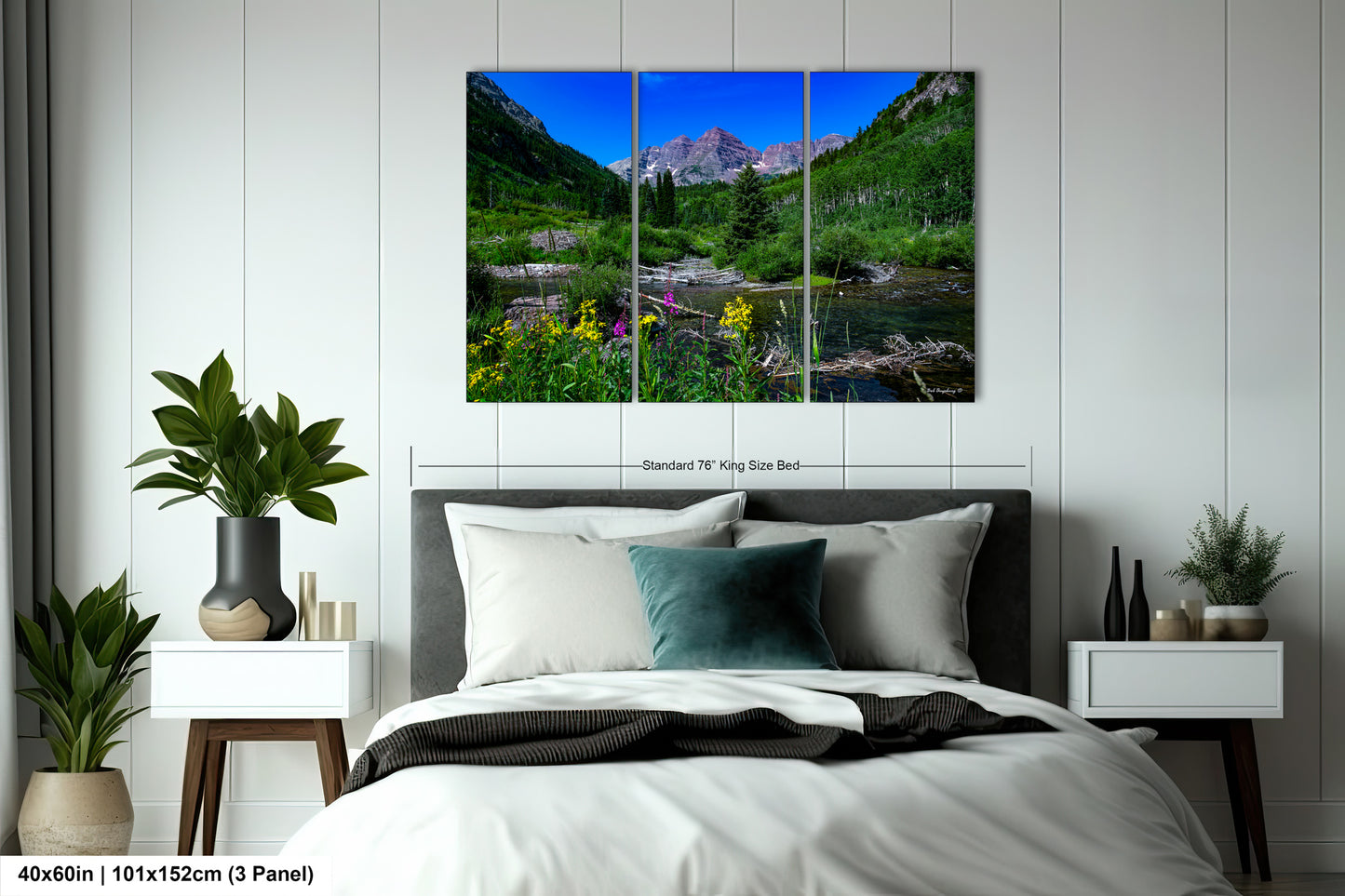 a bed room with a neatly made bed and a painting on the wall