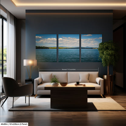 The image is a modern living room with a large wall art depicting a serene landscape of a lake and mountains. The room is furnished with a white sofa, a wooden coffee table, and a large window that allows natural light to fill the space.