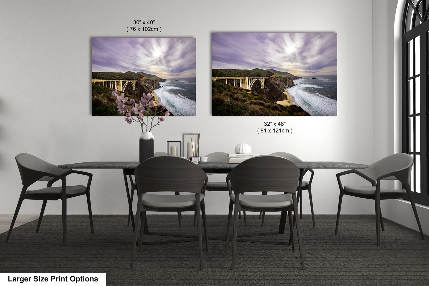 a dining room table with four chairs and two pictures on the wall