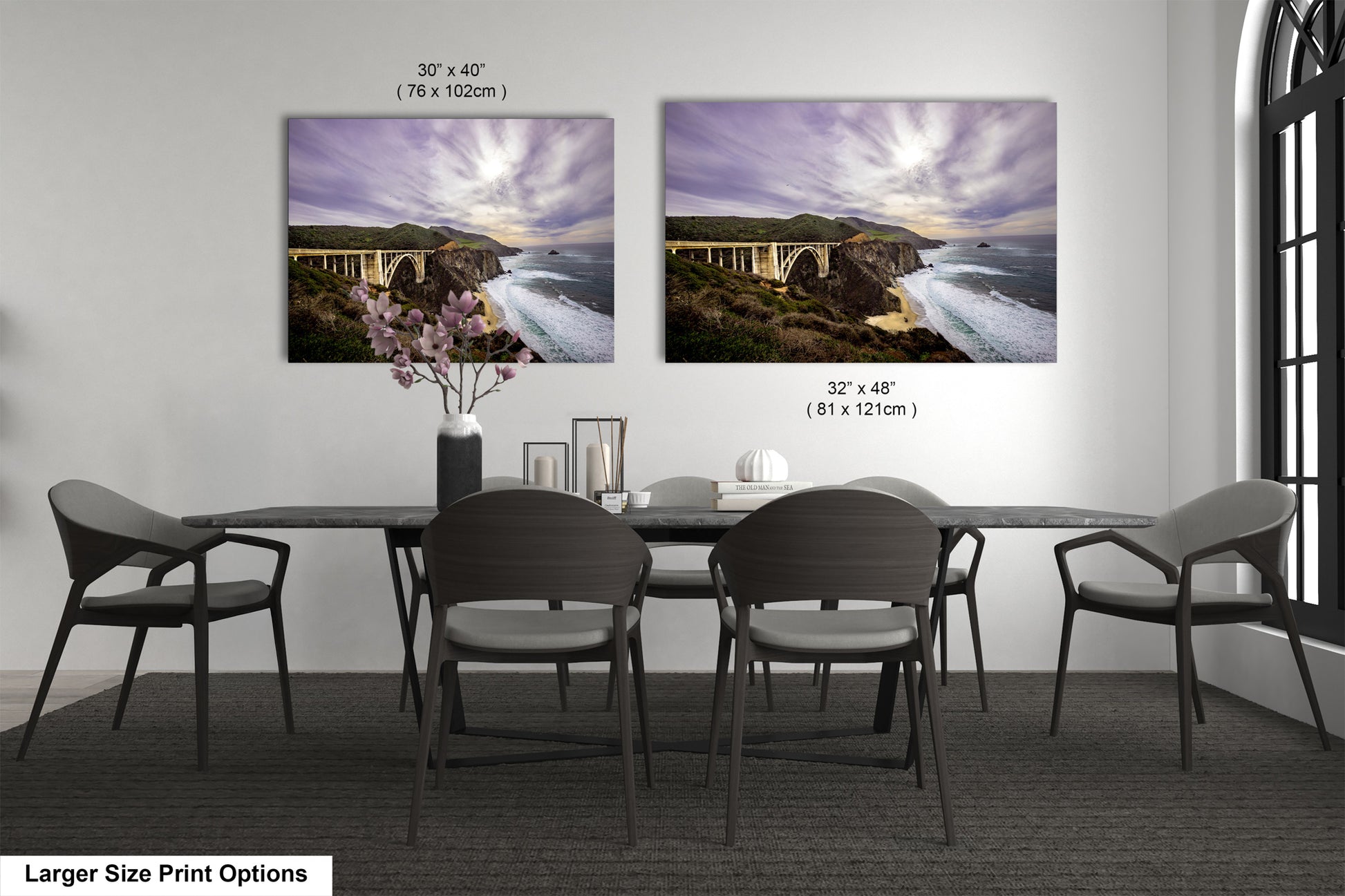 a dining room table with four chairs and two pictures on the wall