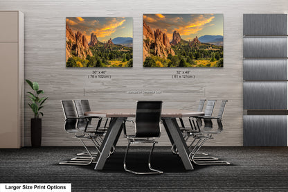 a dining room table with chairs and two pictures on the wall