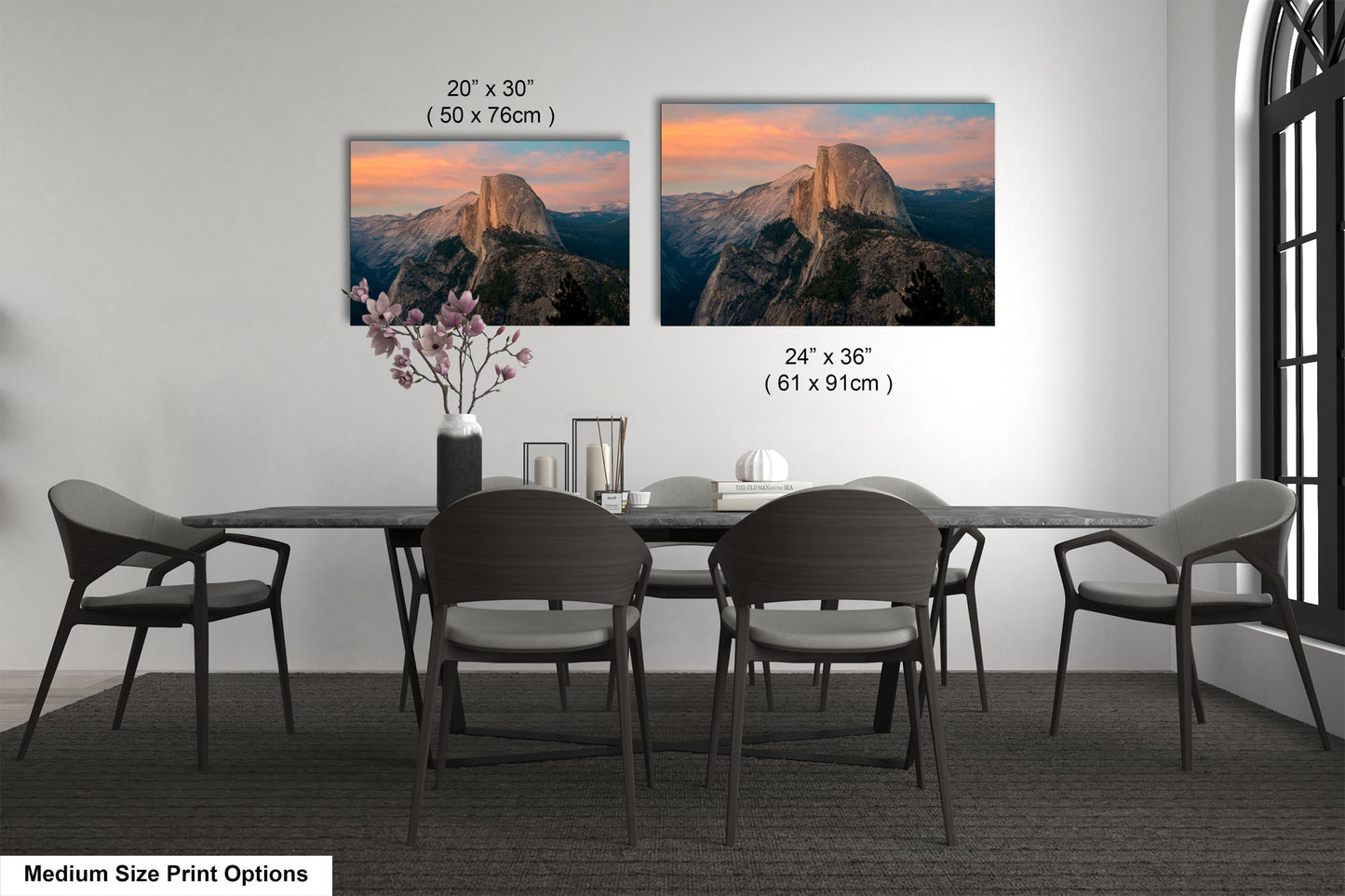 a dining table with four chairs and a vase with flowers