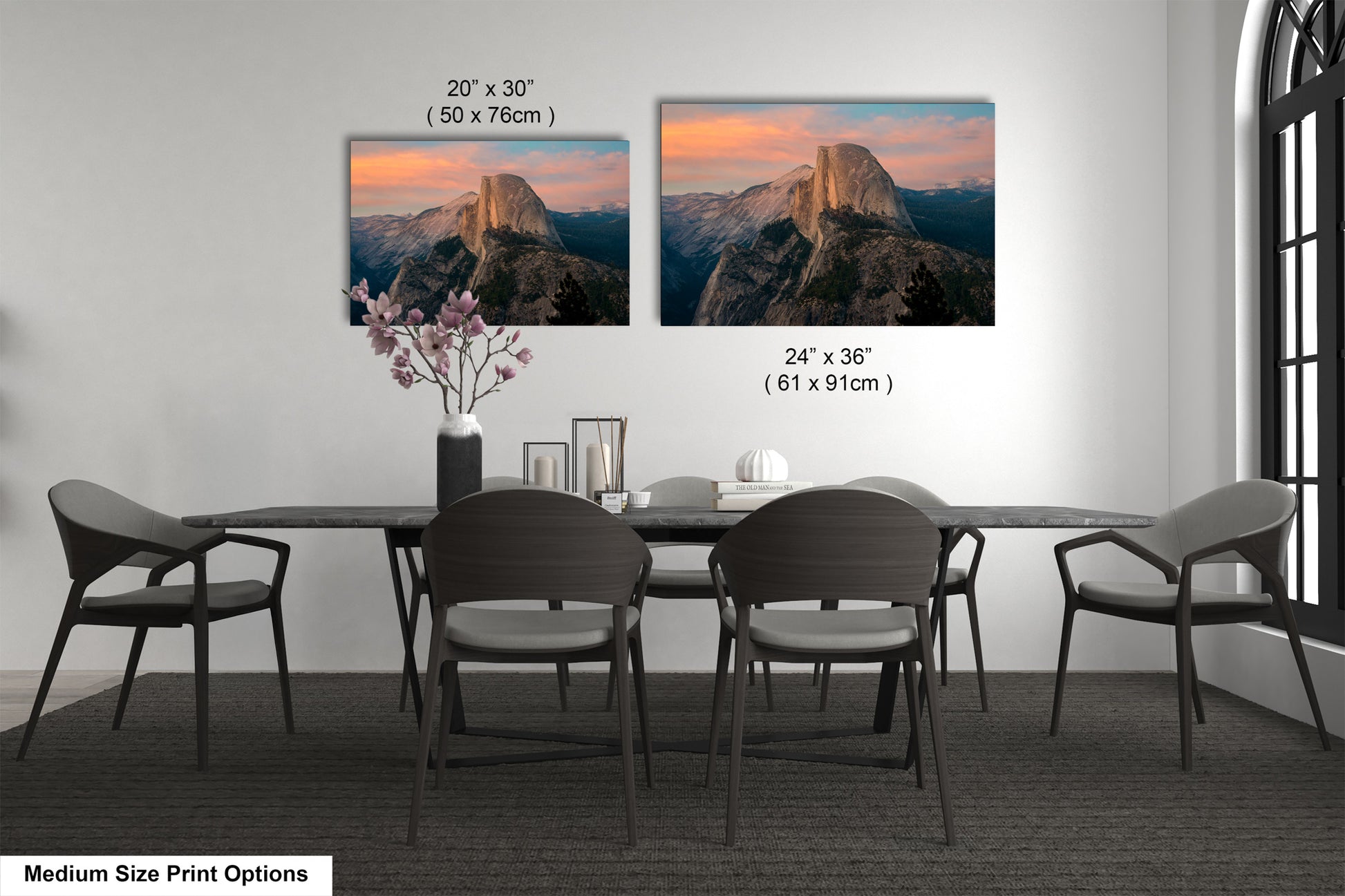 a dining table with four chairs and a vase with flowers
