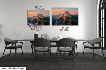 a dining table with four chairs and a vase with flowers