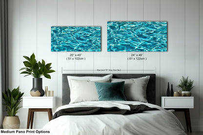 a bedroom with a bed, nightstands, and a large painting of water on the wall above the bed.