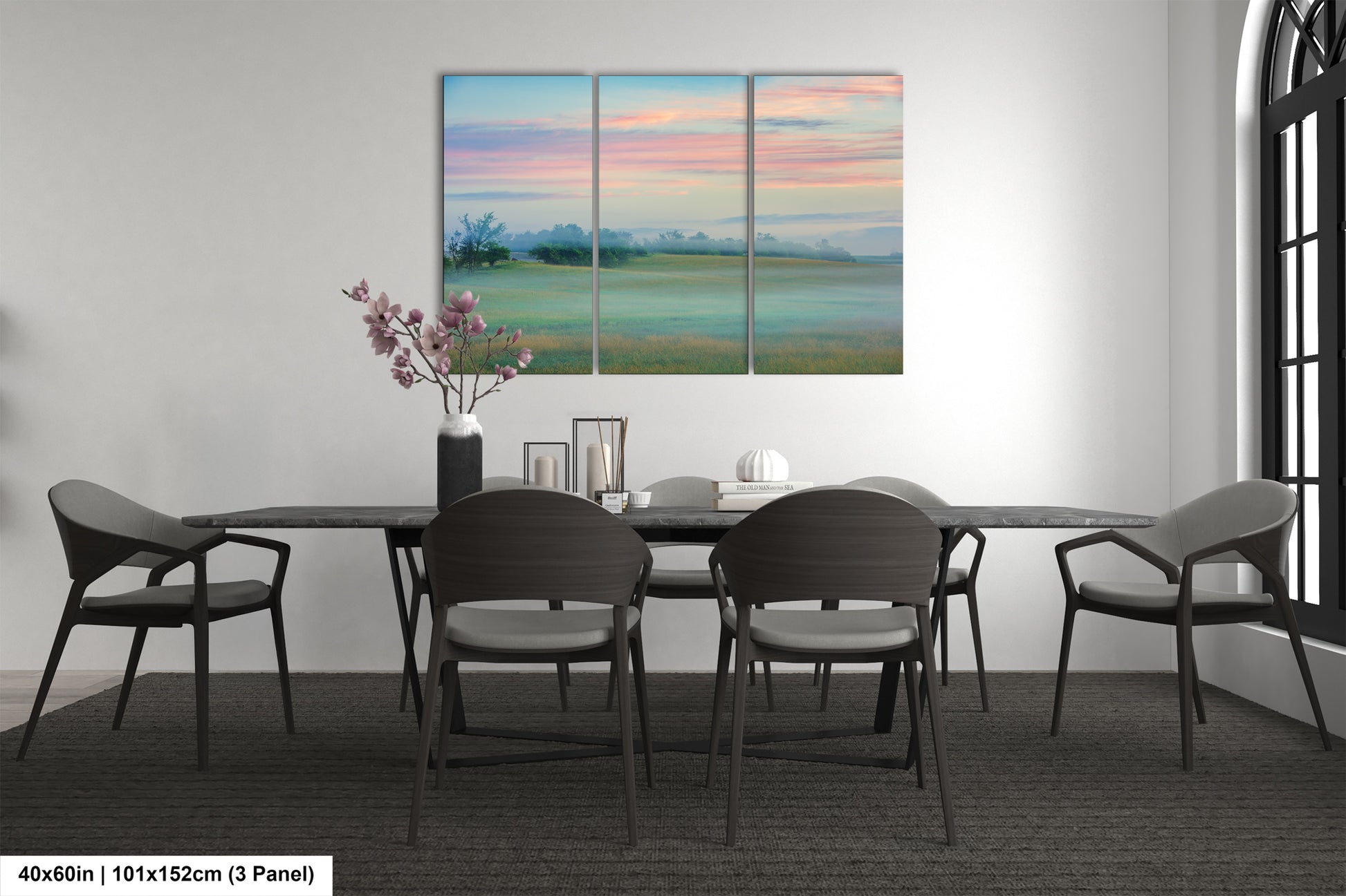 a dining room table with four chairs and a painting on the wall