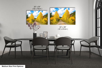 a dining room table with four chairs and two pictures on the wall