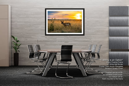 a modern office space with a large framed landscape painting of a deer in a field, hanging on the wall above a wooden table surrounded by chairs.
