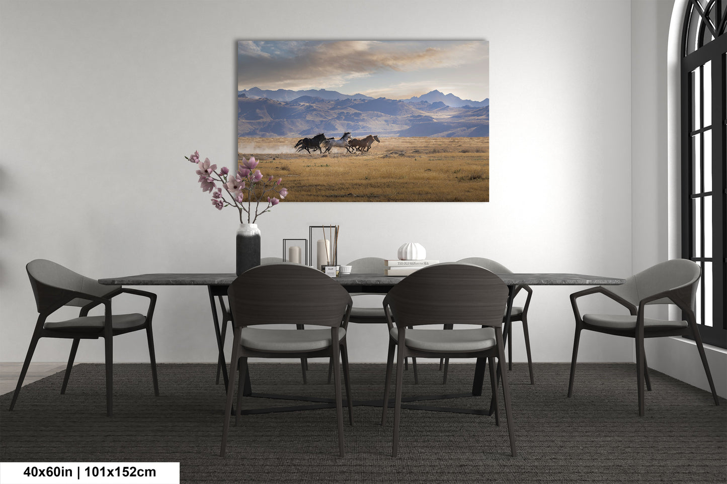 a dining room table with chairs and a painting on the wall