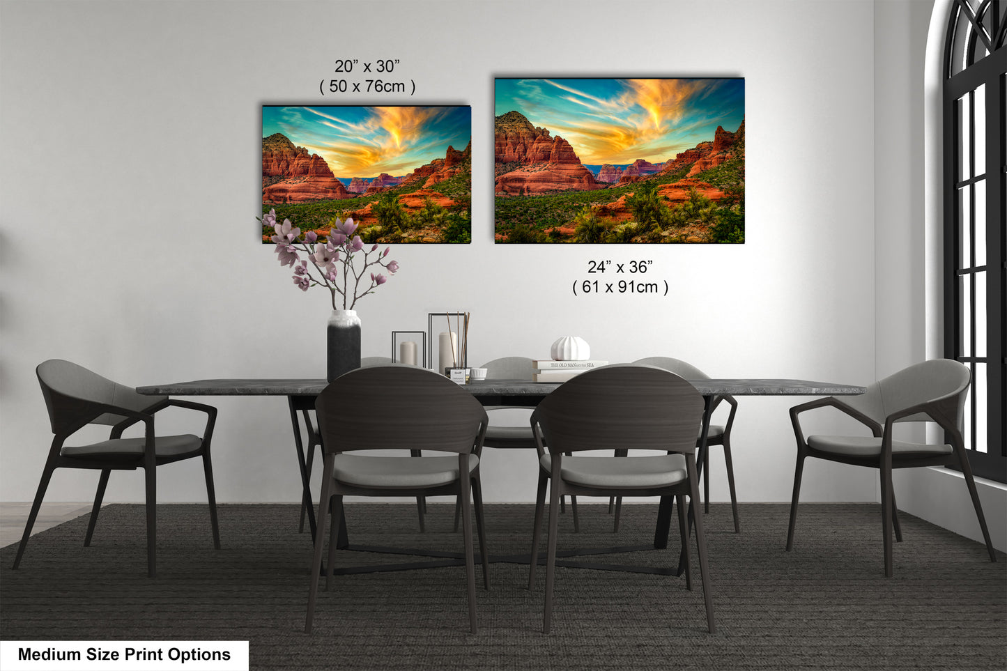 a dining table with four chairs and a vase with flowers