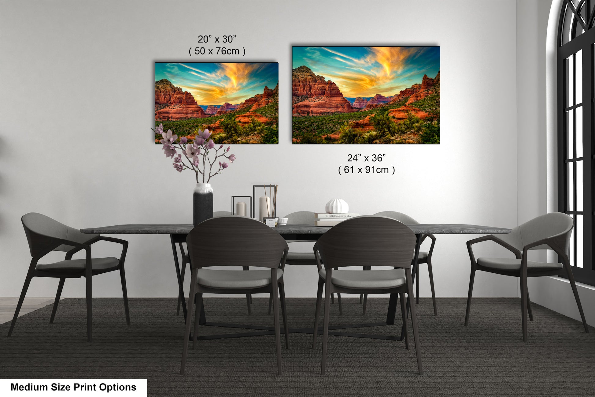 a dining table with four chairs and a vase with flowers