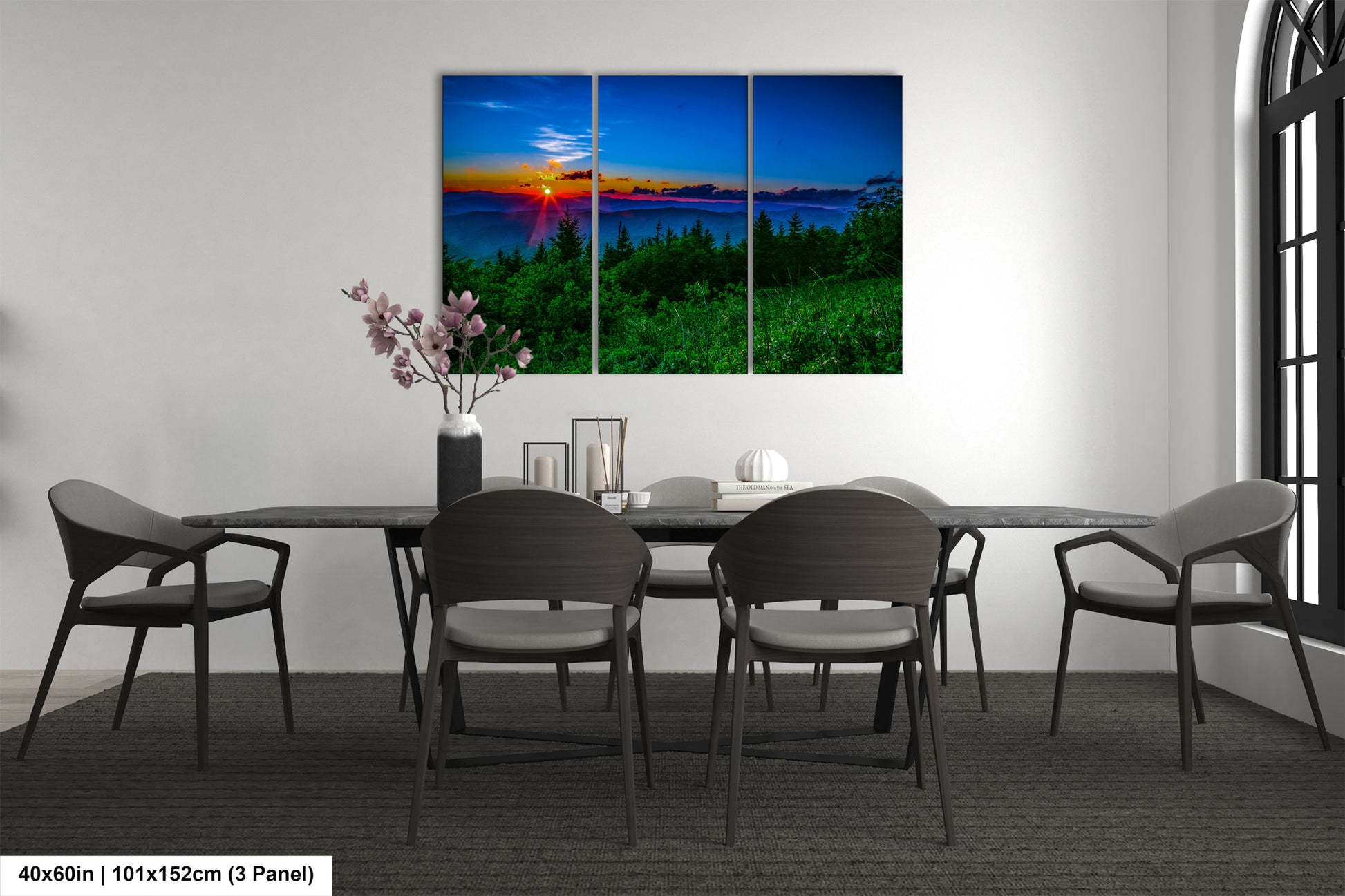 a dining room table with four chairs and a painting on the wall