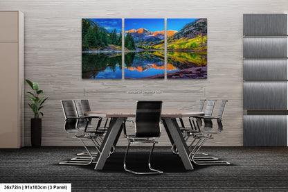 a dining room table with chairs and a painting on the wall