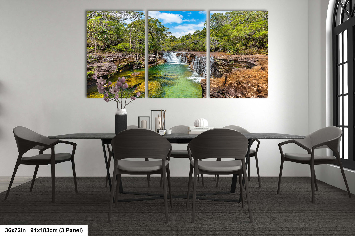 a dining room table with chairs and a painting on the wall