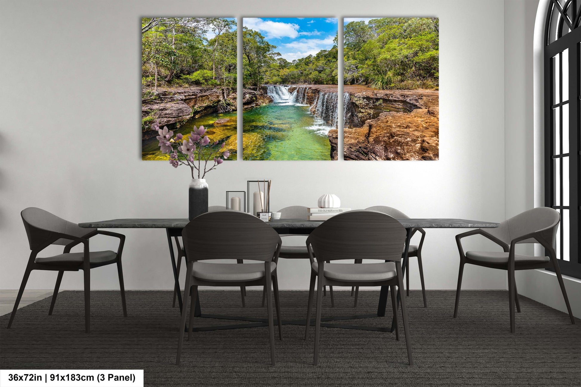 a dining room table with chairs and a painting on the wall