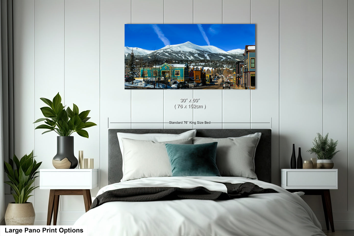 a bedroom with a large bed and a mountain in the background