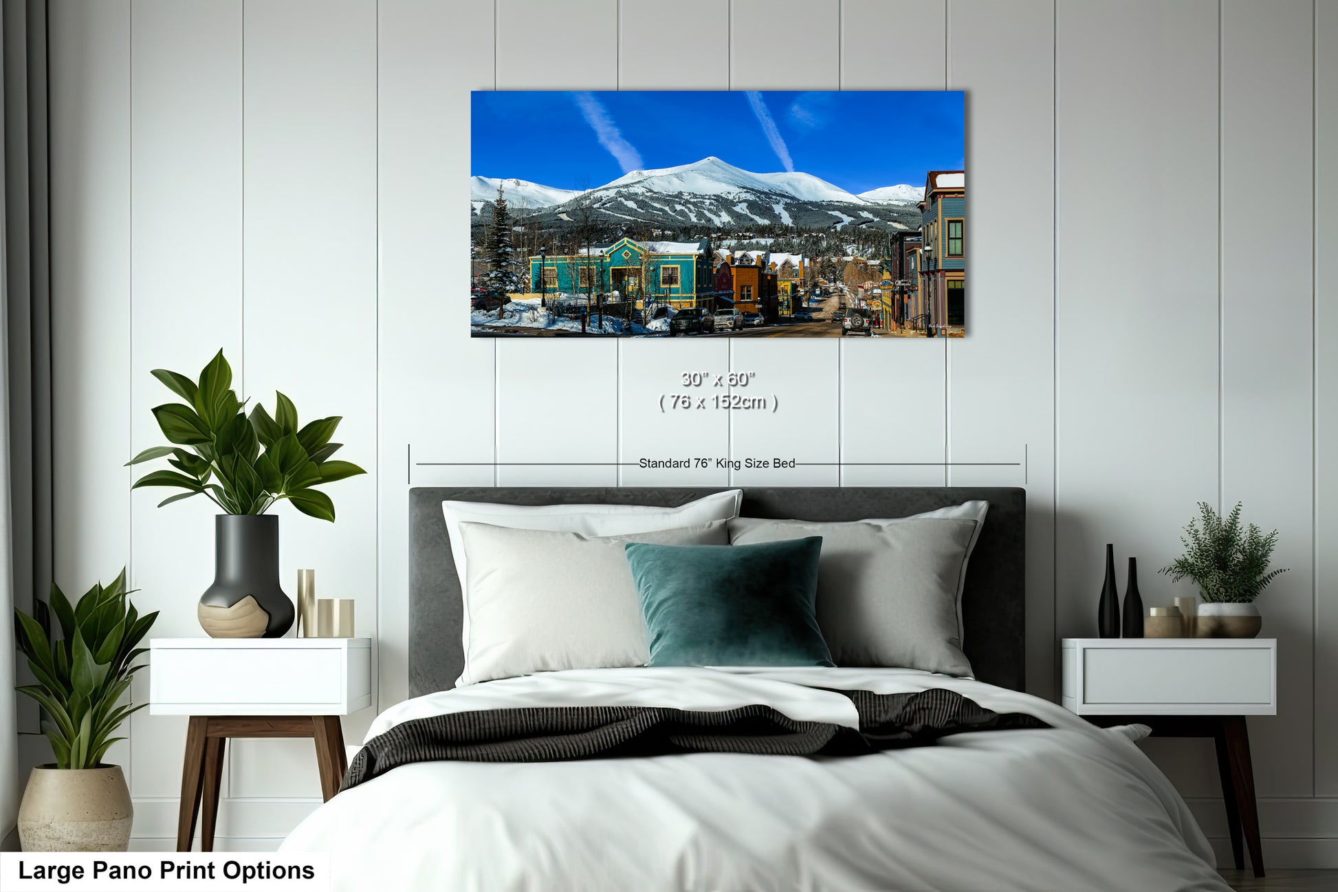 a bedroom with a large bed and a mountain in the background