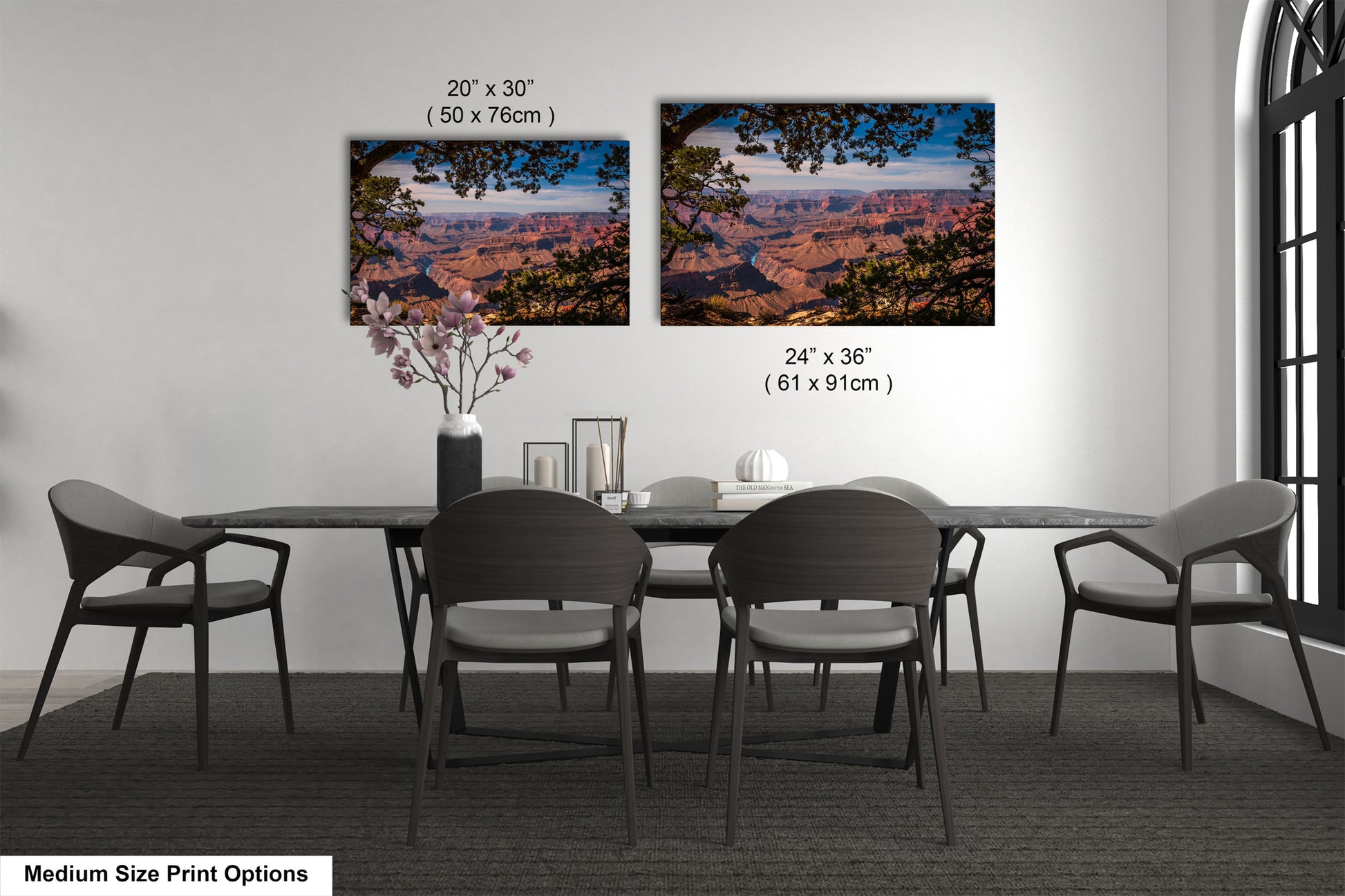 a dining table with four chairs and a vase with flowers