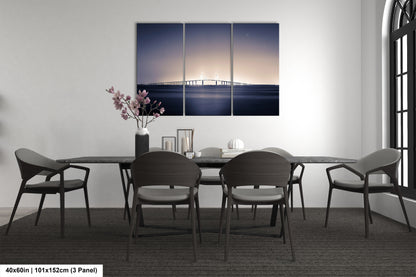 a dining room table with chairs and a painting on the wall