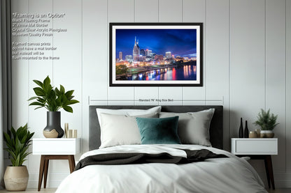a bedroom with a picture of a city at night