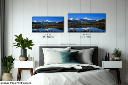 a bedroom with a bed and two pictures on the wall