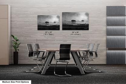 a dining room table with four chairs and two pictures on the wall