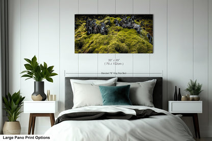 a bedroom with a large bed and a painting on the wall