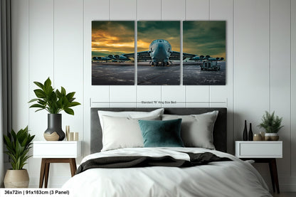 a bedroom with a bed and three paintings on the wall