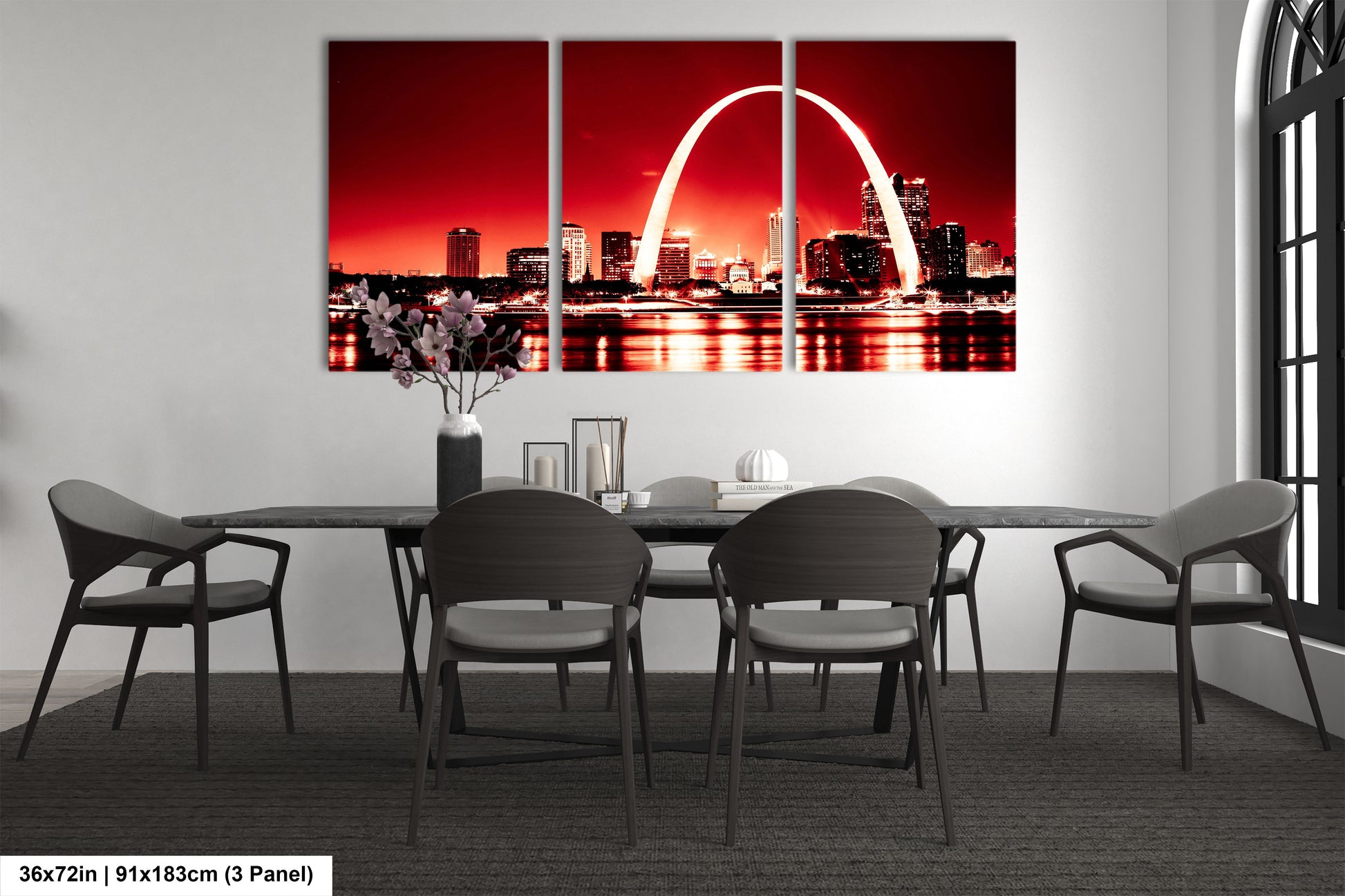 a dining room with a table and chairs and a picture of the st louis arch