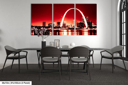 a dining room with a table and chairs and a picture of the st louis arch