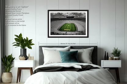 a bedroom with a bed and a picture of a football field