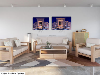a modern living room with a large sofa, two chairs, and a coffee table. There are two framed photographs of a building on the wall, and the text indicates that the larger size print options are available.