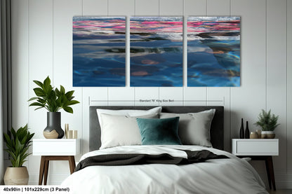 a bedroom with a bed and two paintings on the wall