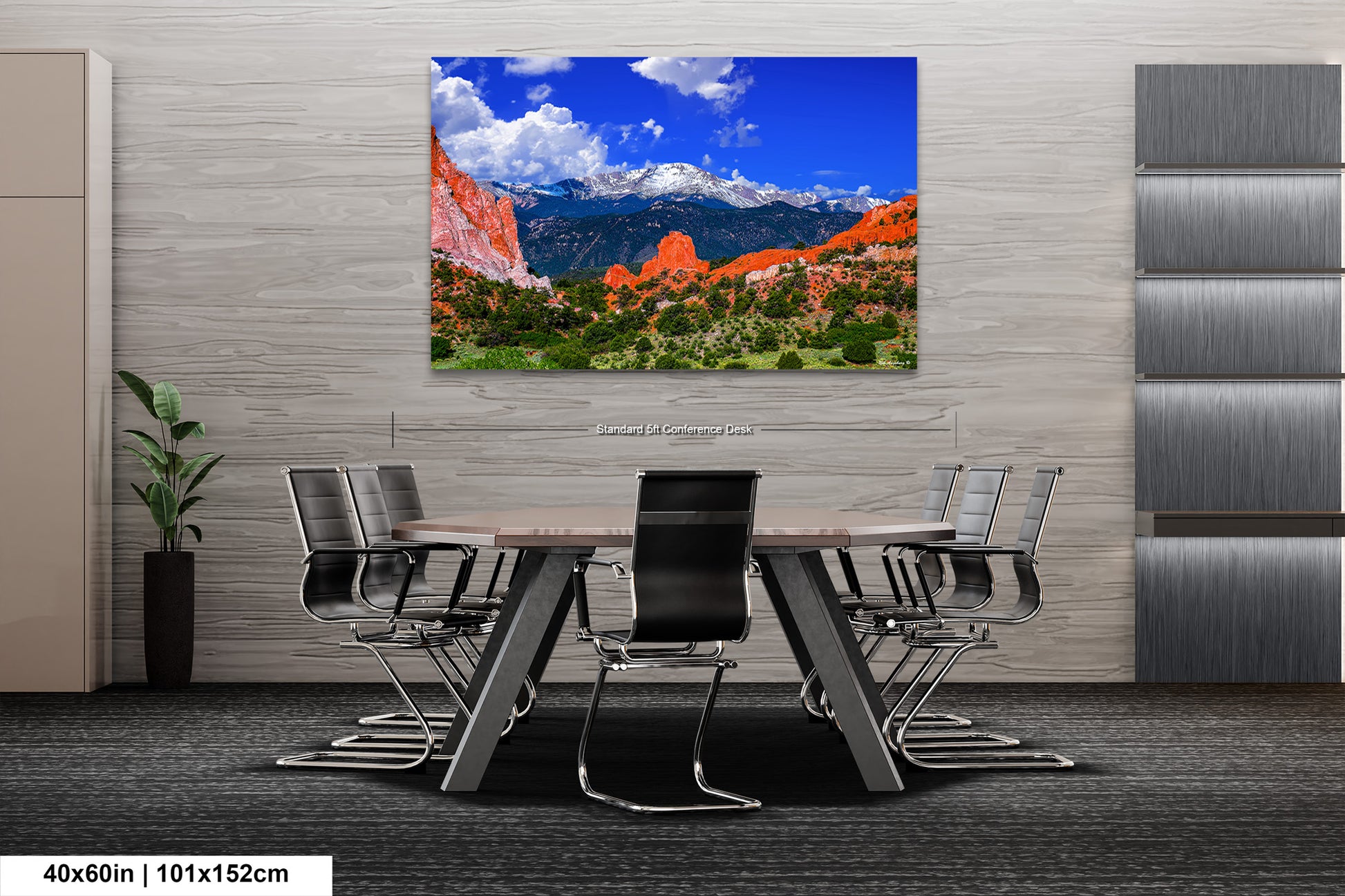 a dining room table with chairs and a painting on the wall