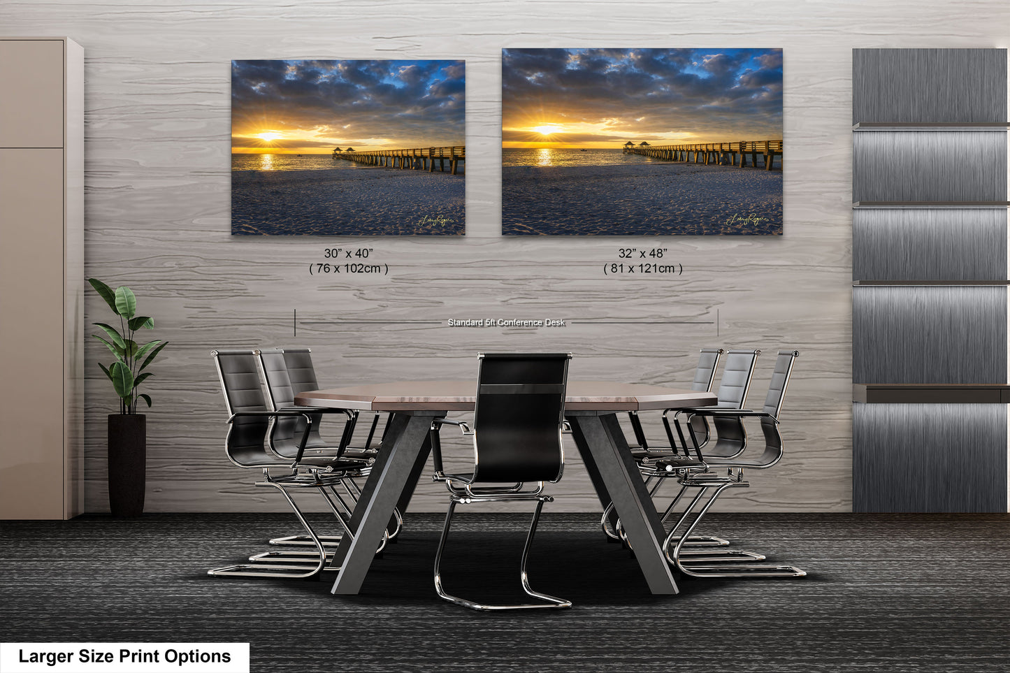 a dining room table with chairs in front of a wall with two pictures of a