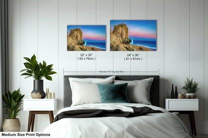 a bedroom with a bed and two pictures on the wall